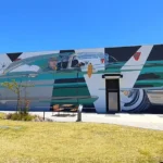 Finished mural at Dunreath Village Shopping Centre showing a pilot driving a customised 1950s-era Lincoln, captured by Sitevisuals